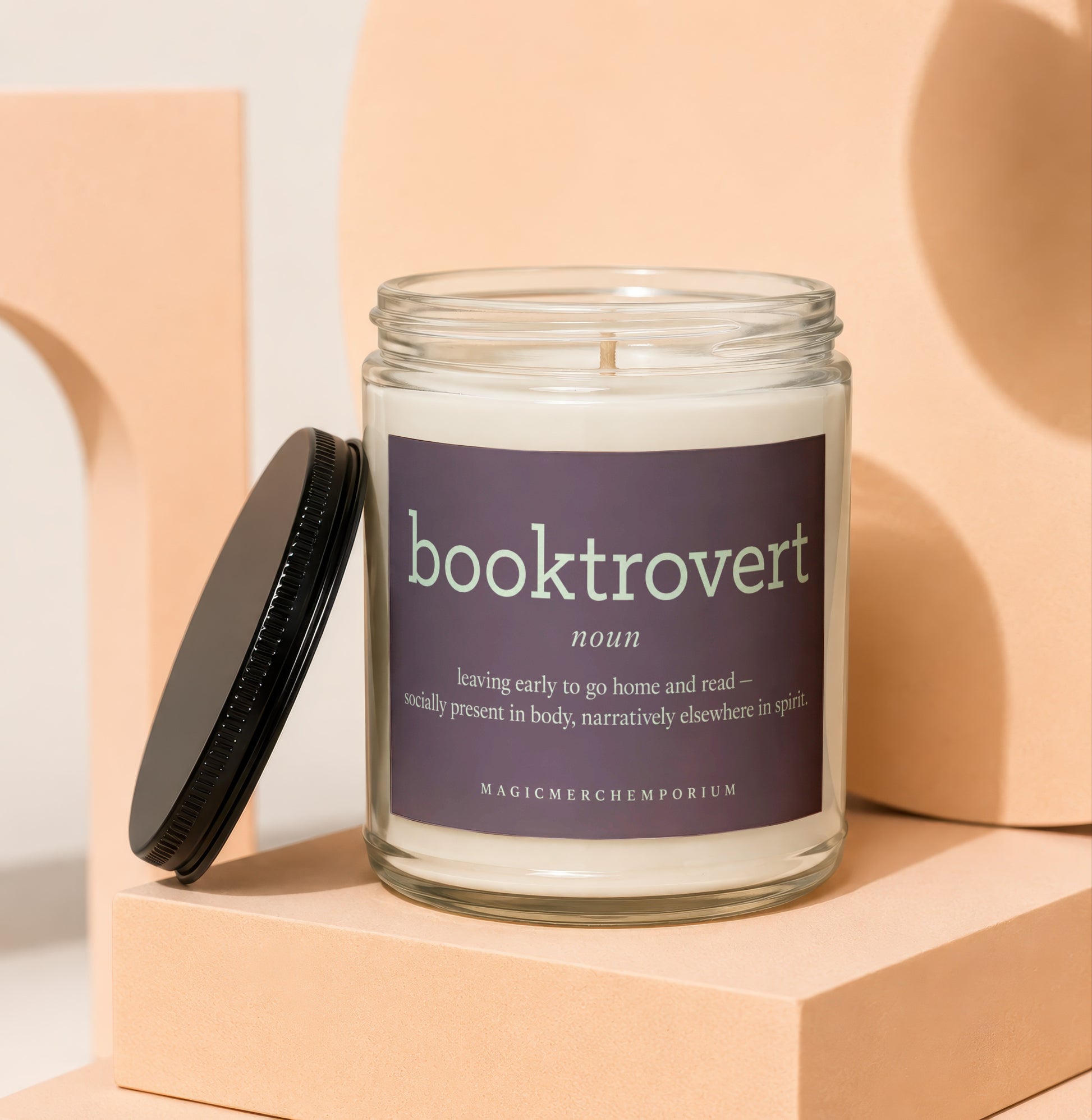 Glass jar candle with "booktrovert noun: leaving early to go home and read" label.