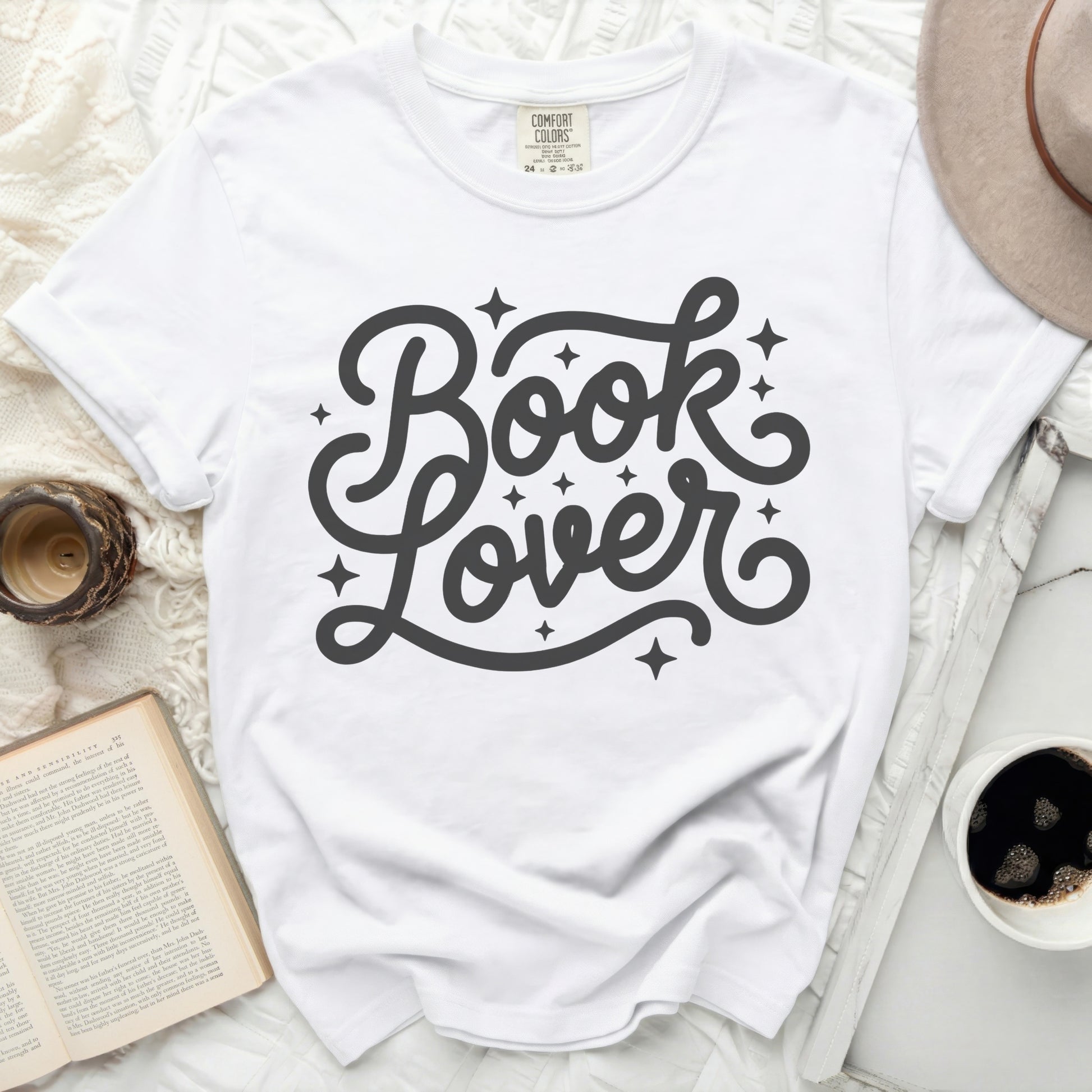 White t-shirt with "Book Lover" in a decorative script font.