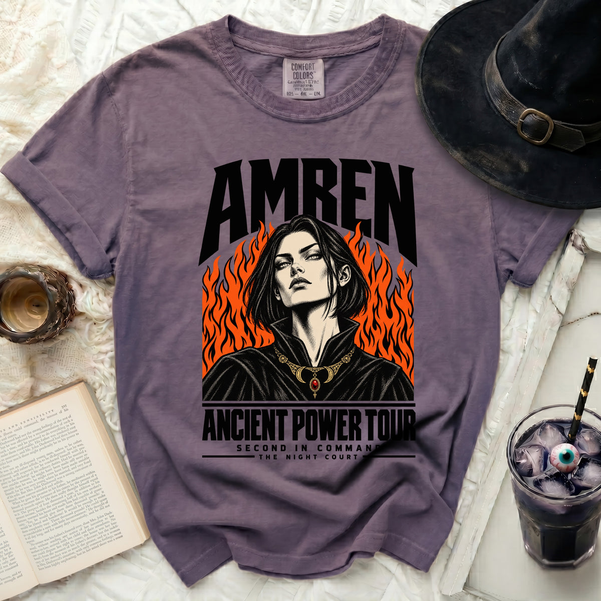 Purple t-shirt with "AMREN" text and a woman graphic with flames.