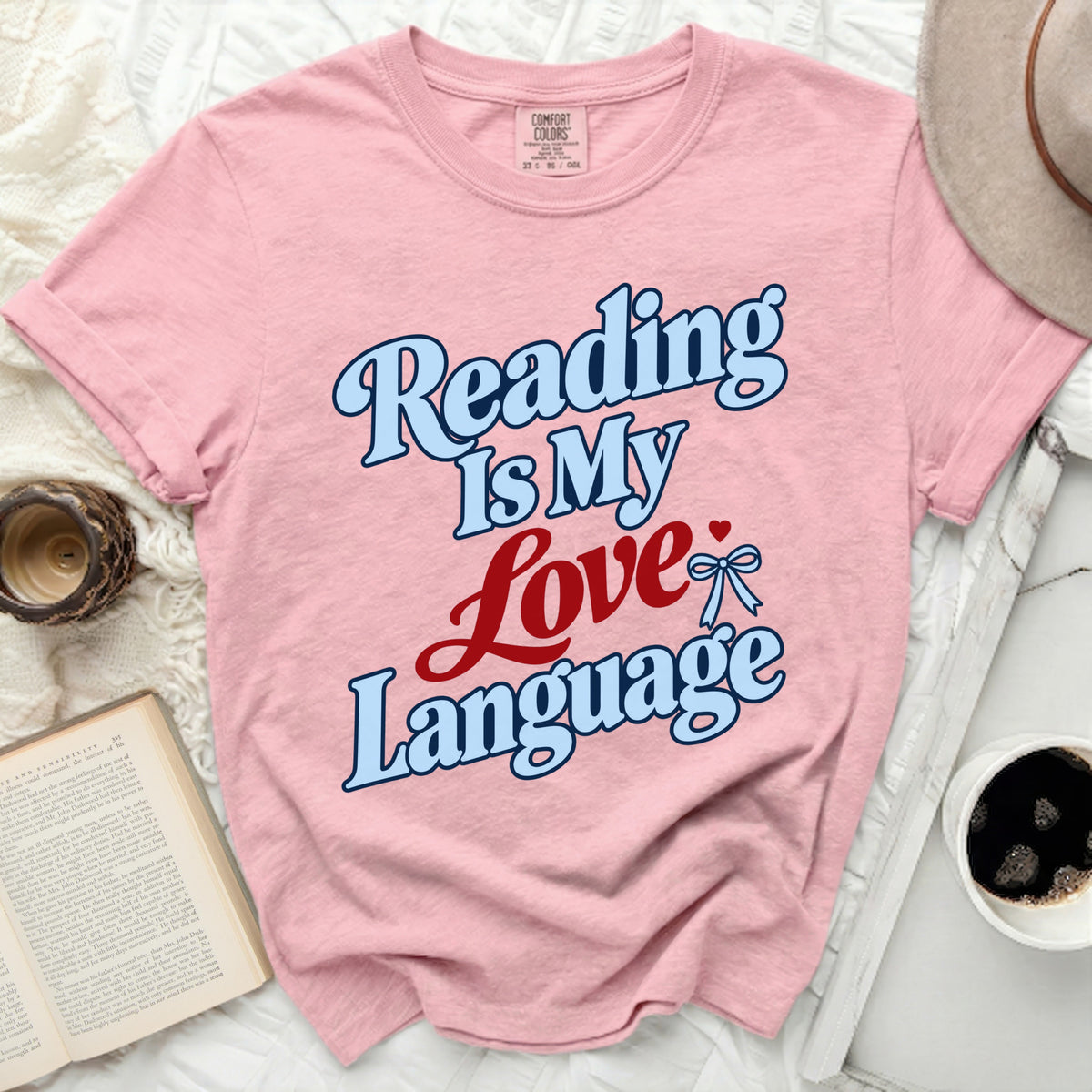 Pink t-shirt with "Reading Is My Love Language" text and a bow.