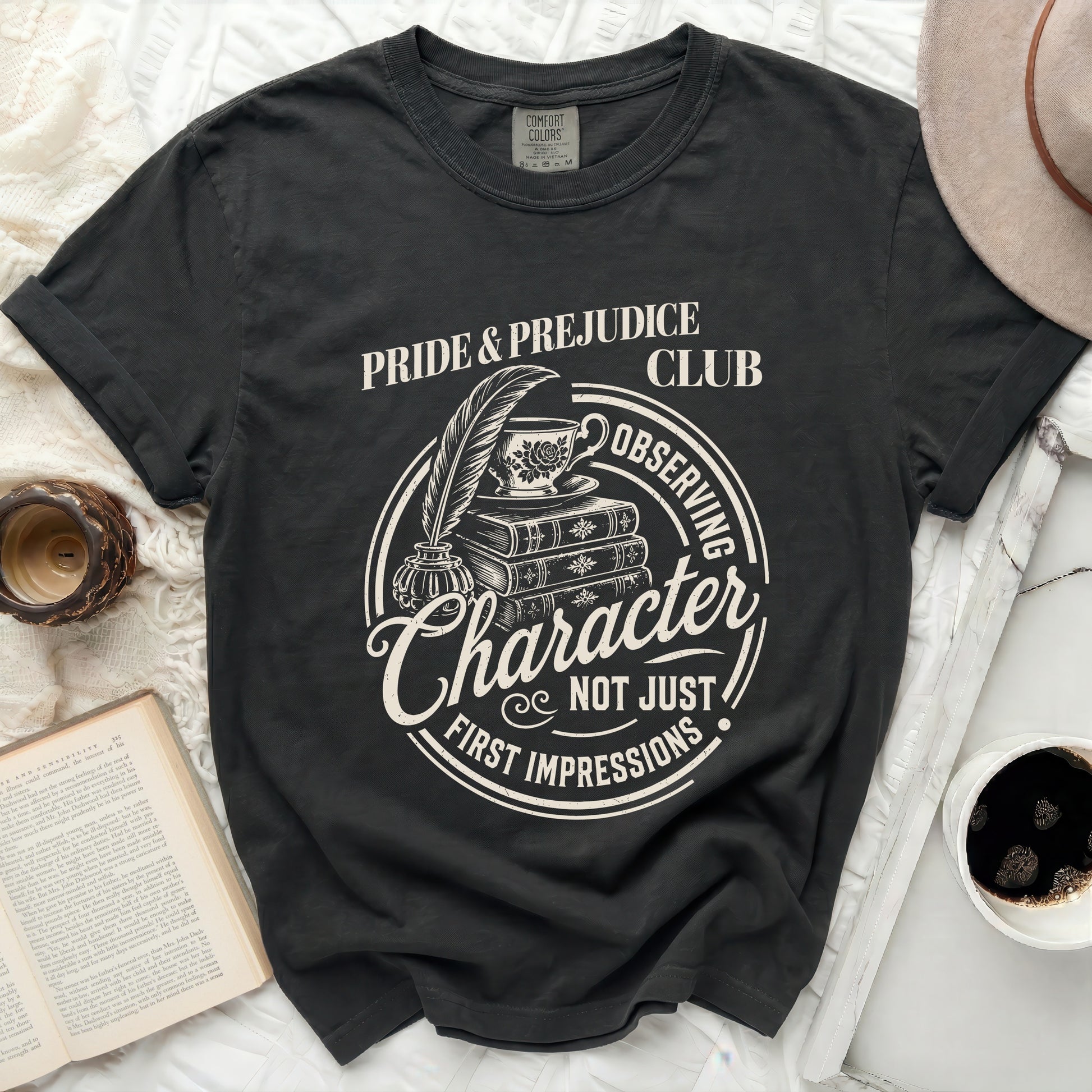 Black t-shirt with "Pride & Prejudice Club" graphic and tea set.