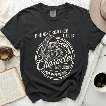 Black t-shirt with "Pride & Prejudice Club" graphic and tea set.