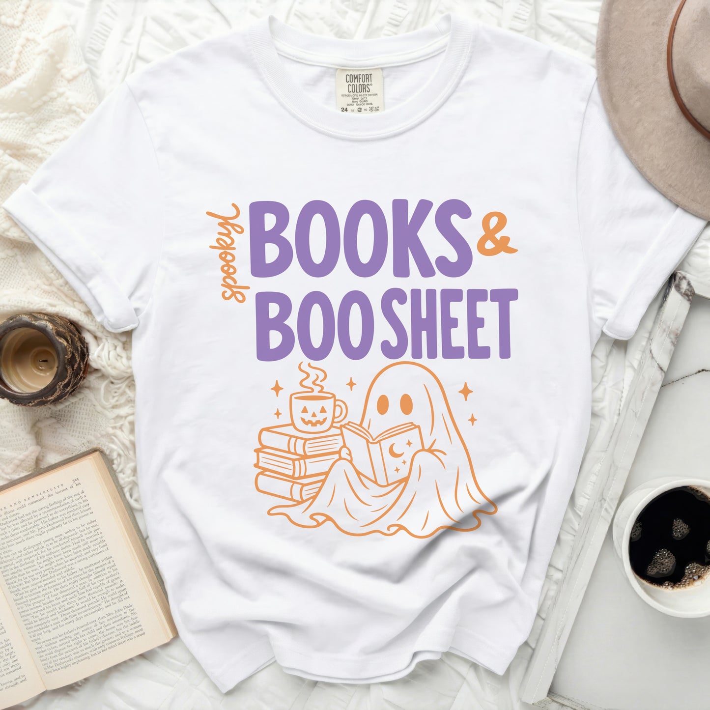 White t-shirt featuring "spooky BOOKS & BOO SHEET" graphic with a ghost reading.