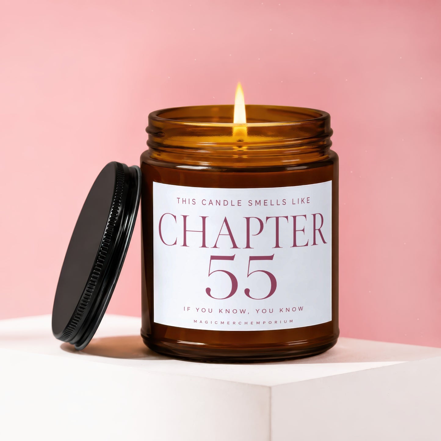 Amber candle with lit wick, lid off, labeled "Chapter 55".