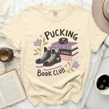 Cream t-shirt with "Pucking Book Club" and hockey skates graphic.