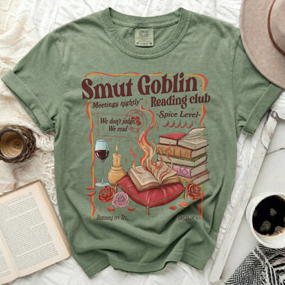 Green t-shirt with "Smut Goblin Reading Club" graphic and books.