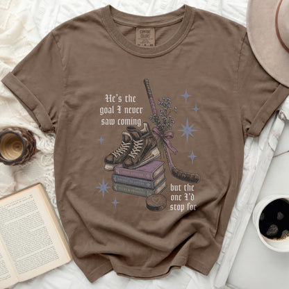 Brown t-shirt with vintage book pile, hockey stick, and romantic text.