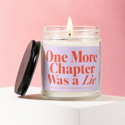 Lit candle in glass jar with black lid, reading "One More Chapter Was a Lie".
