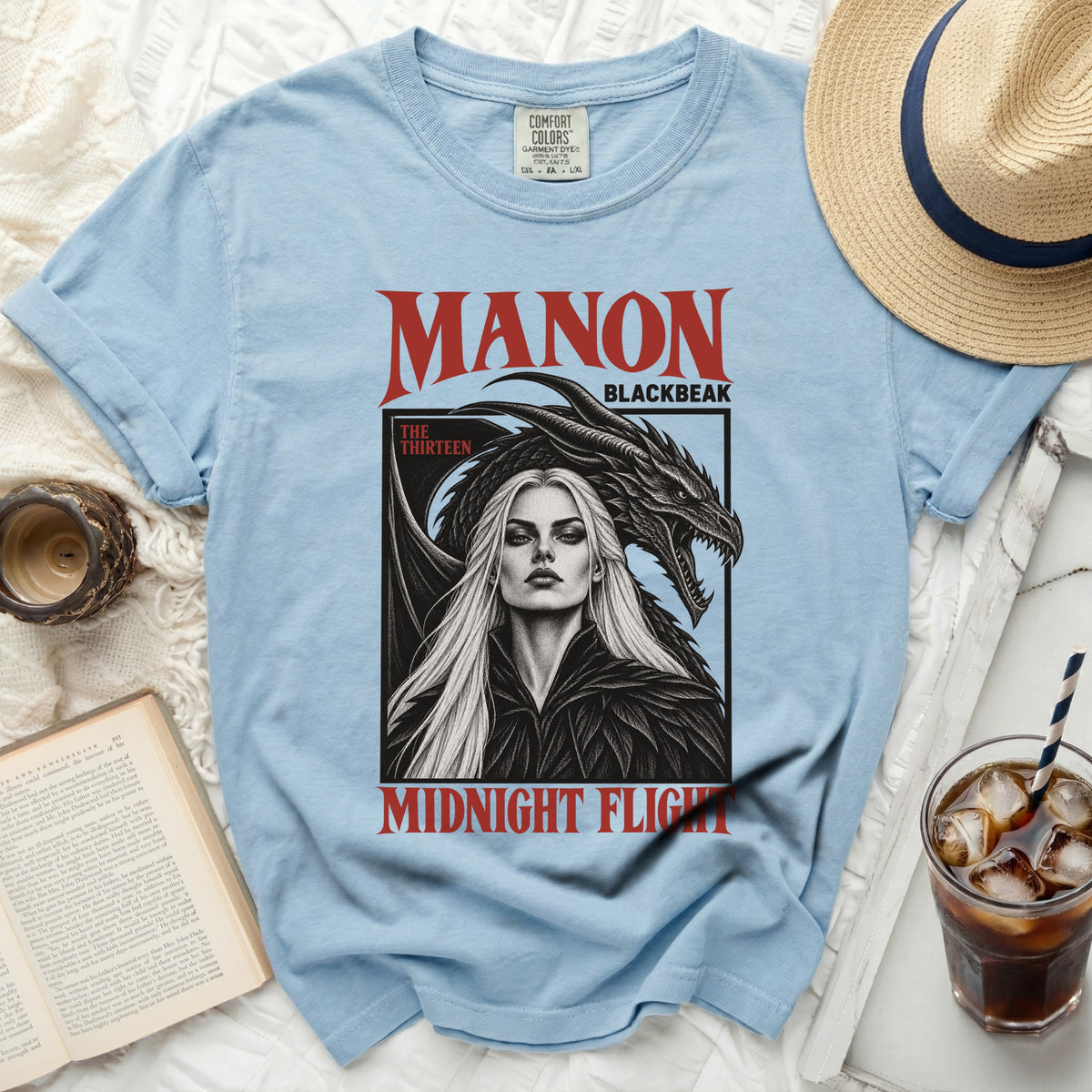 Light blue t-shirt with "MANON BLACKBEAK" and dragon art.