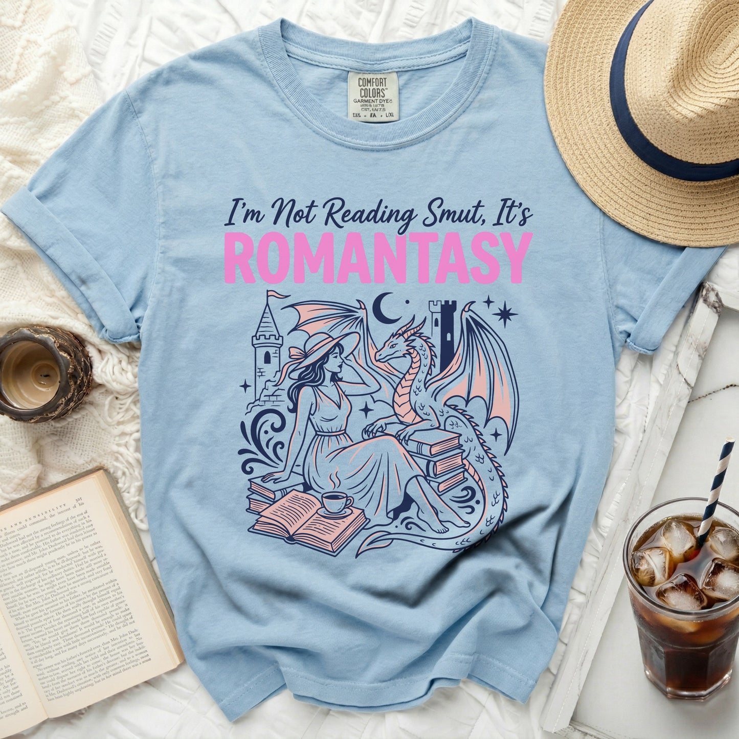Light blue t-shirt with "I'm Not Reading Smut, It's ROMANTASY" text and dragon illustration.