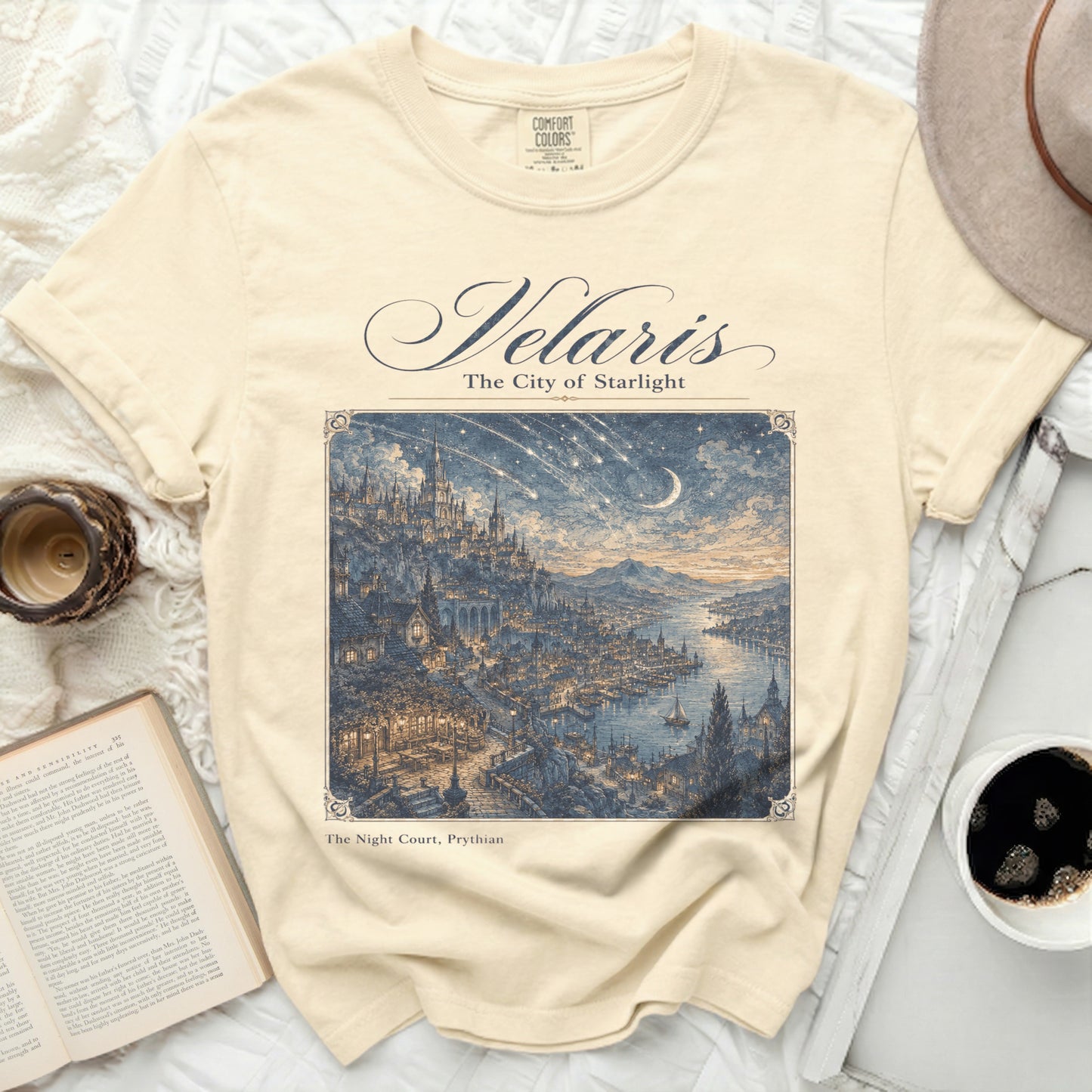 Cream t-shirt with "Velaris The City of Starlight" and a detailed city illustration.