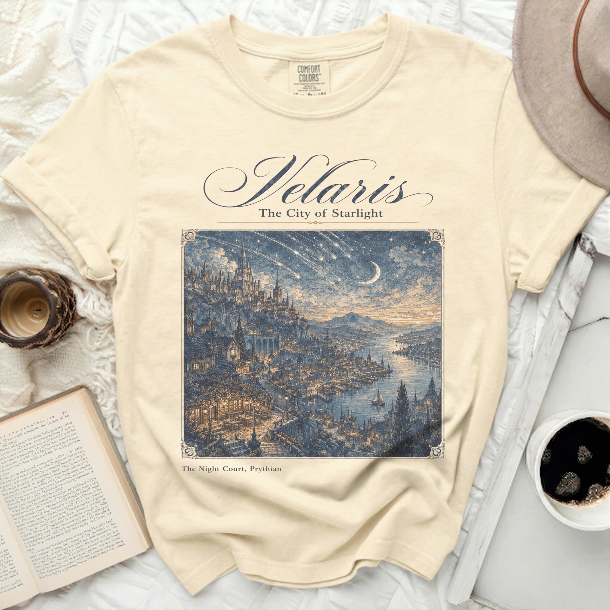 Cream t-shirt with "Velaris The City of Starlight" and a detailed city illustration.