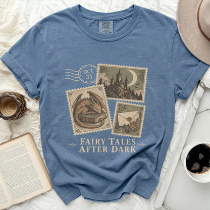 Blue t-shirt with "Fairy Tales After Dark" and vintage postage stamp graphics.