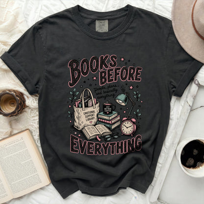 Dark t-shirt with "Books Before Everything" graphic and reading-themed illustrations.