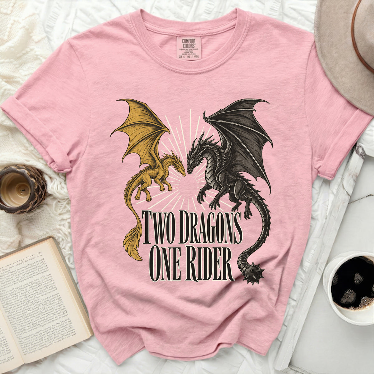 Pink t-shirt with graphic of two dragons and text "TWO DRAGONS ONE RIDER".