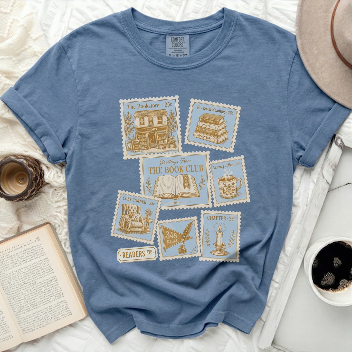 Blue t-shirt with vintage postcard designs for "The Book Club."