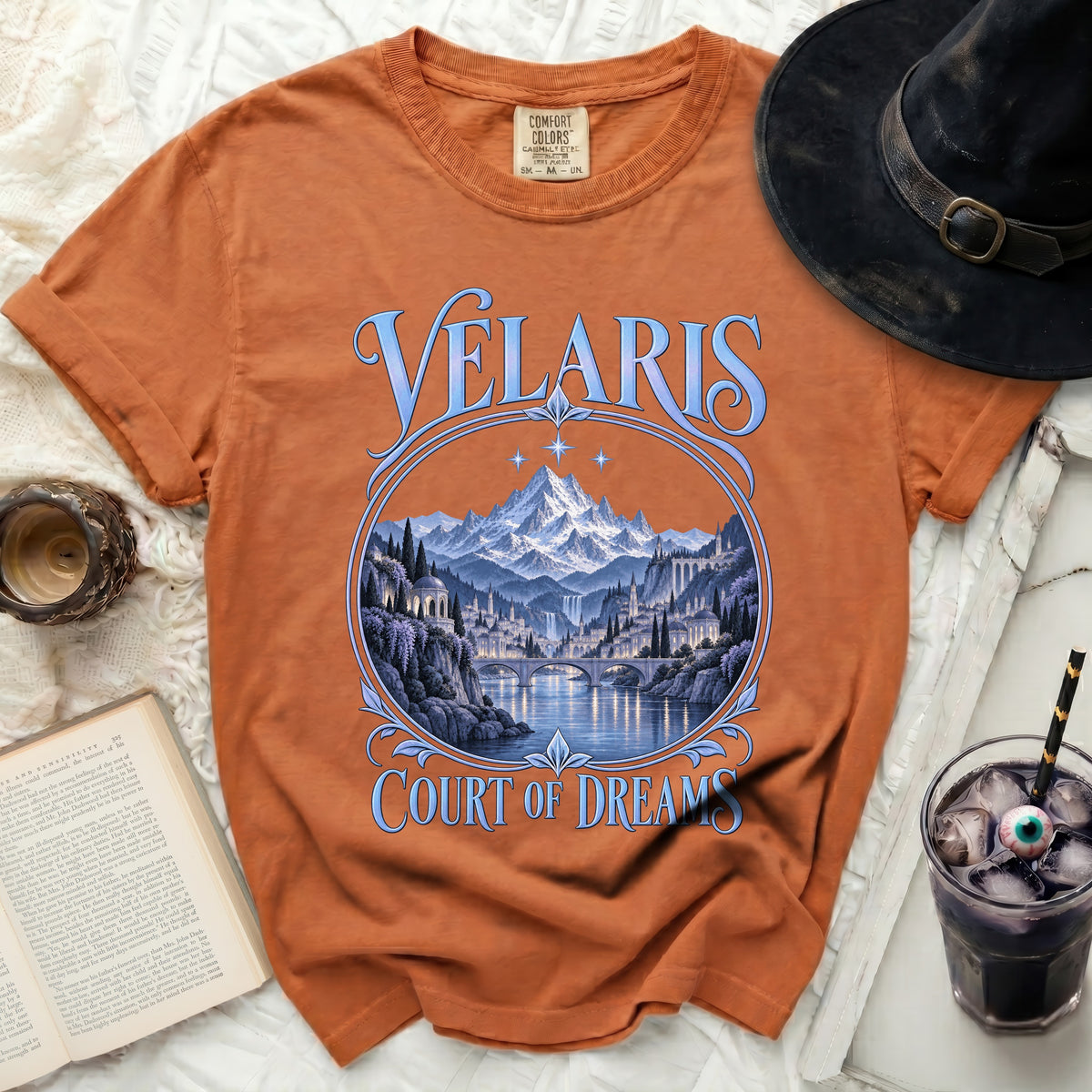 Orange t-shirt with "Velaris Court of Dreams" text and a fantasy city landscape.