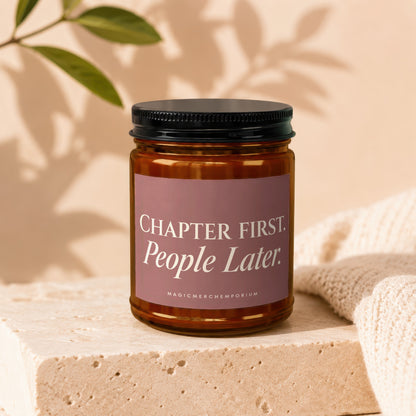 Amber jar candle with black lid displaying "Chapter First. People Later." text.