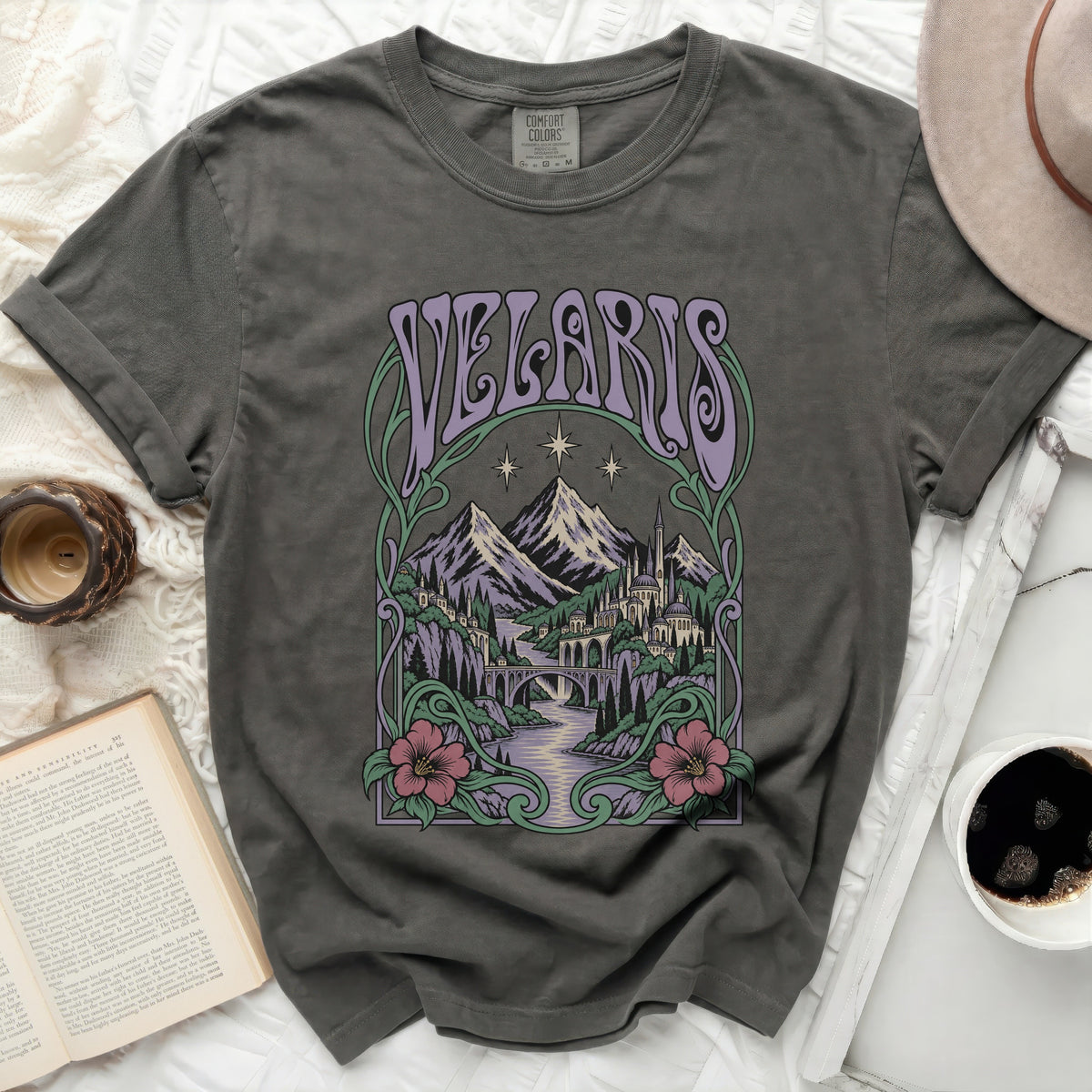 Grey t-shirt with purple "Velaris" text above a fantastical mountain city and river scene.
