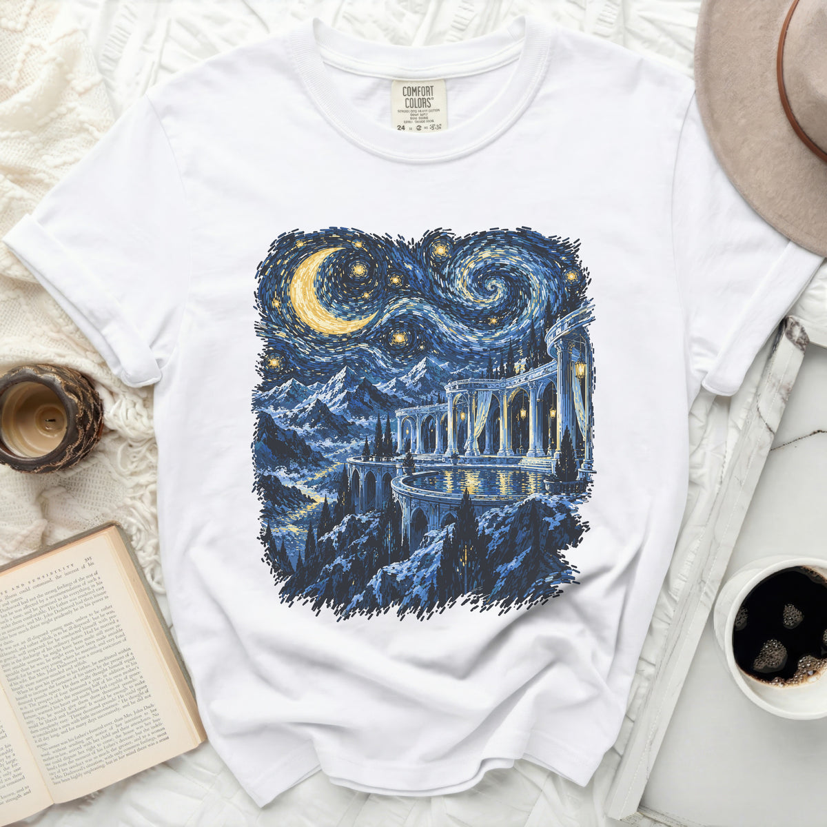 White t-shirt with a starry night landscape featuring mountains and a grand archway.