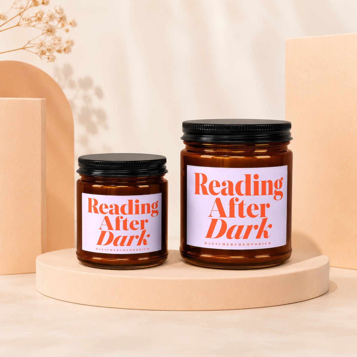 Two amber glass candles in dark jars labeled "Reading After Dark".