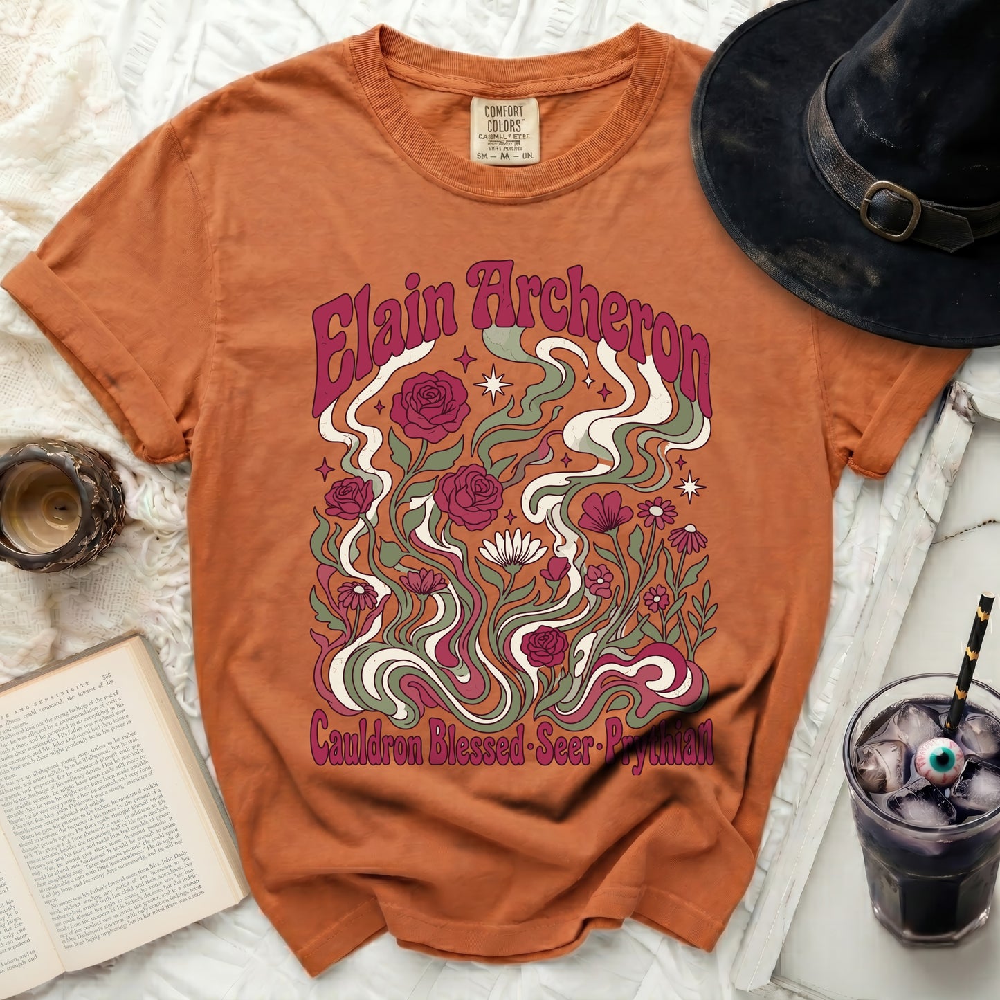 Orange t-shirt with "Elain Acheron" and floral design.