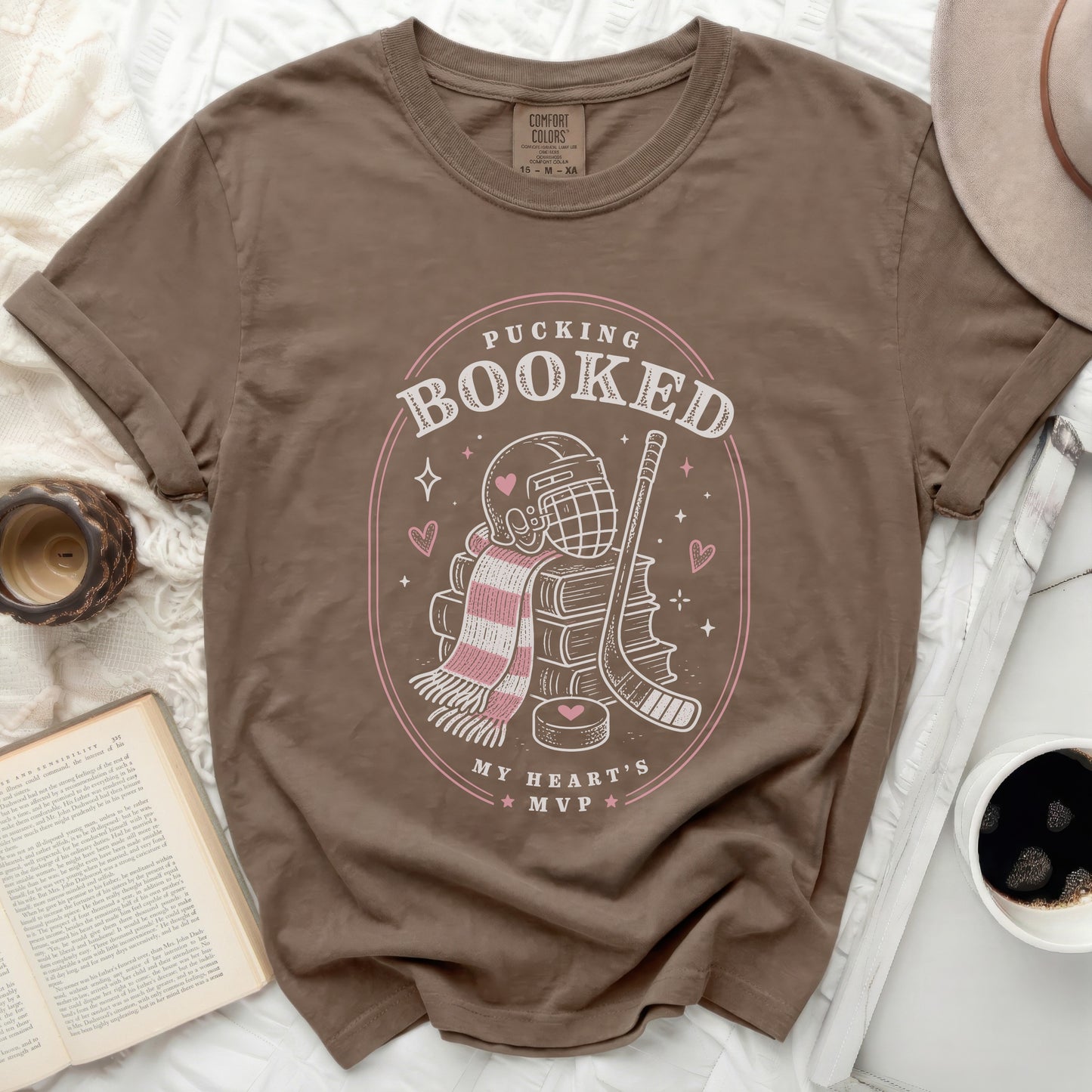 Brown t-shirt with "Pucking Booked My Heart's MVP" graphic.