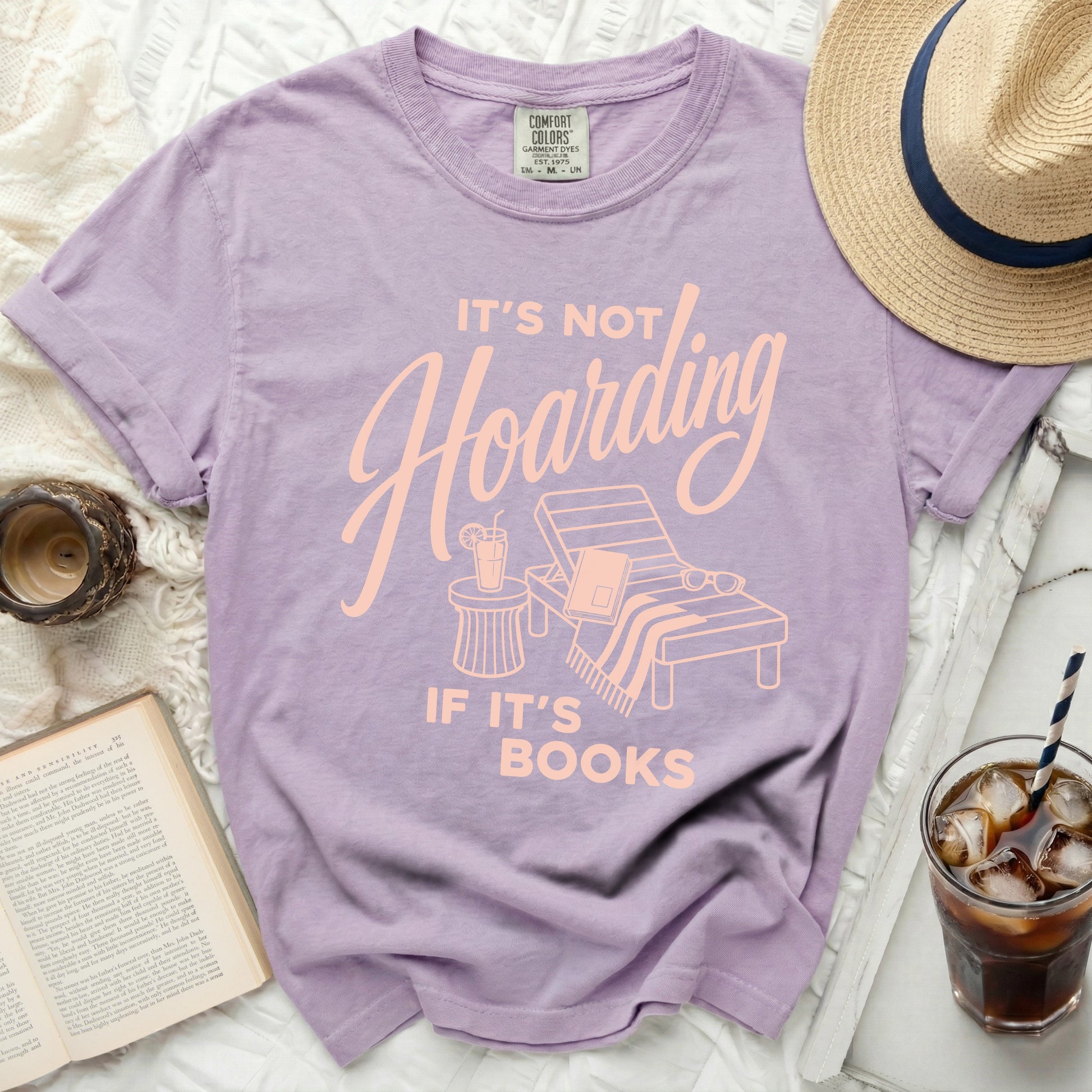 Purple t-shirt with "It's not hoarding if it's books" text.
