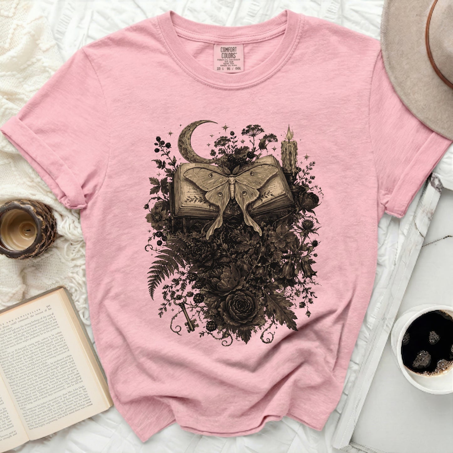 Pink t-shirt with floral luna moth and crescent moon graphic.