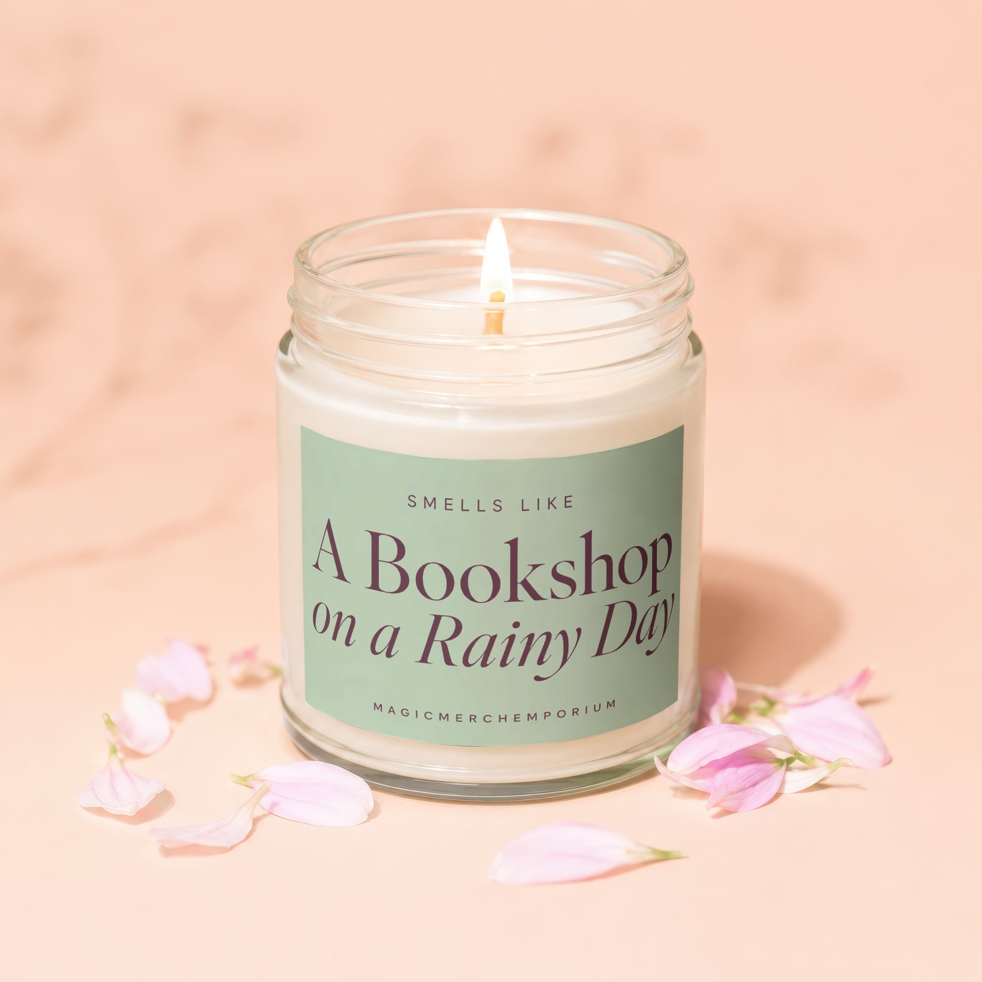 Lit candle with "Smells Like A Bookshop on a Rainy Day" label.