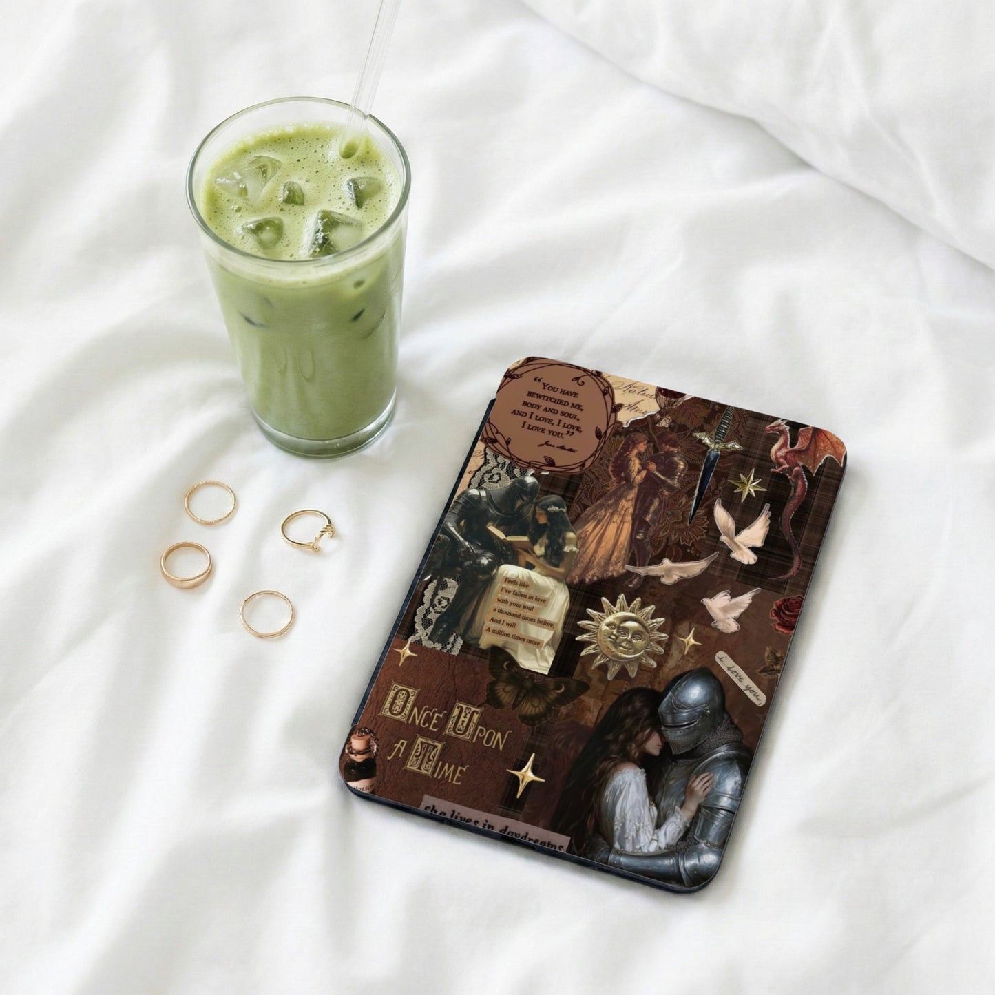 Journal with romantic fantasy collage, quotes, and iced matcha drink.
