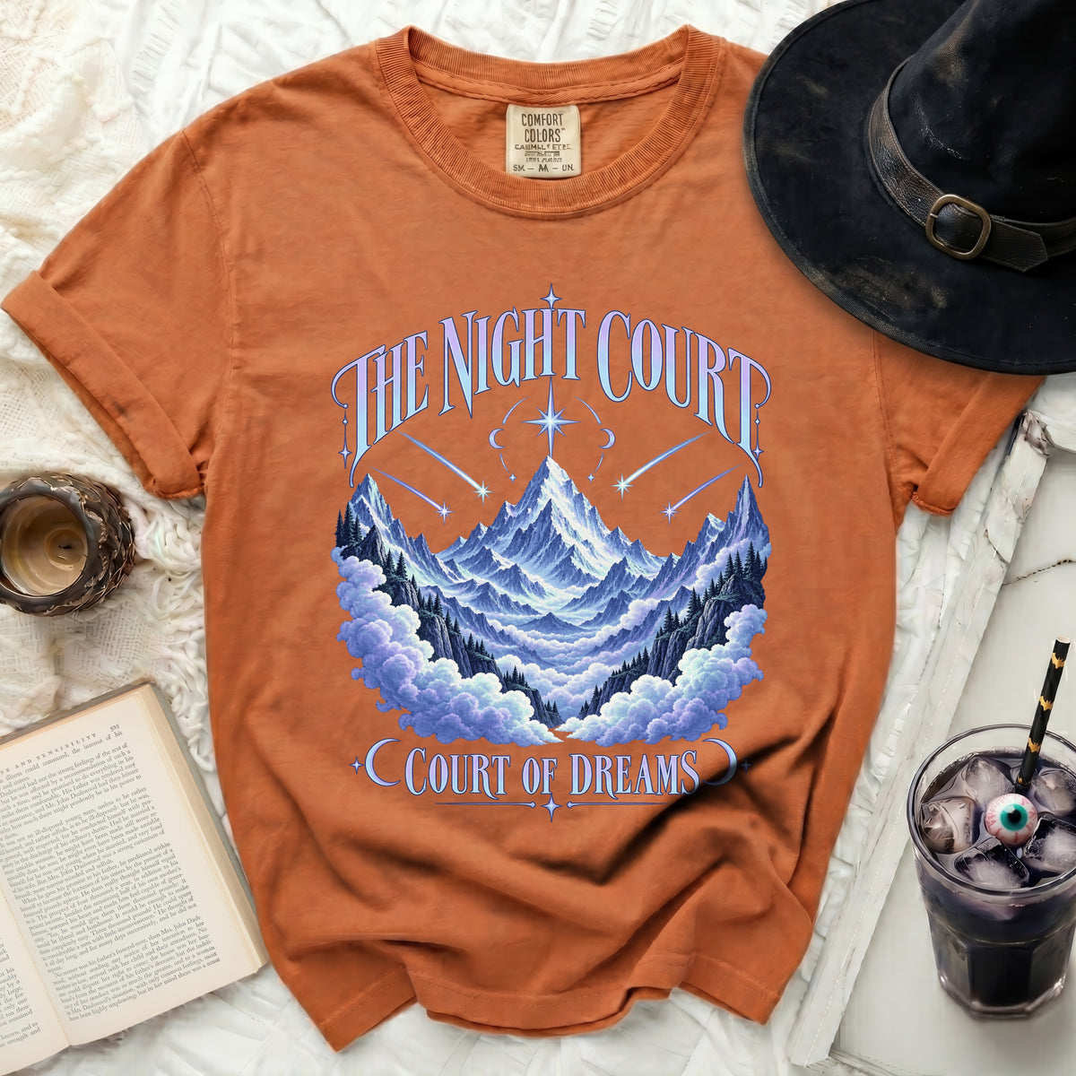 Orange t-shirt with "The Night Court Court of Dreams" text and mountain design.