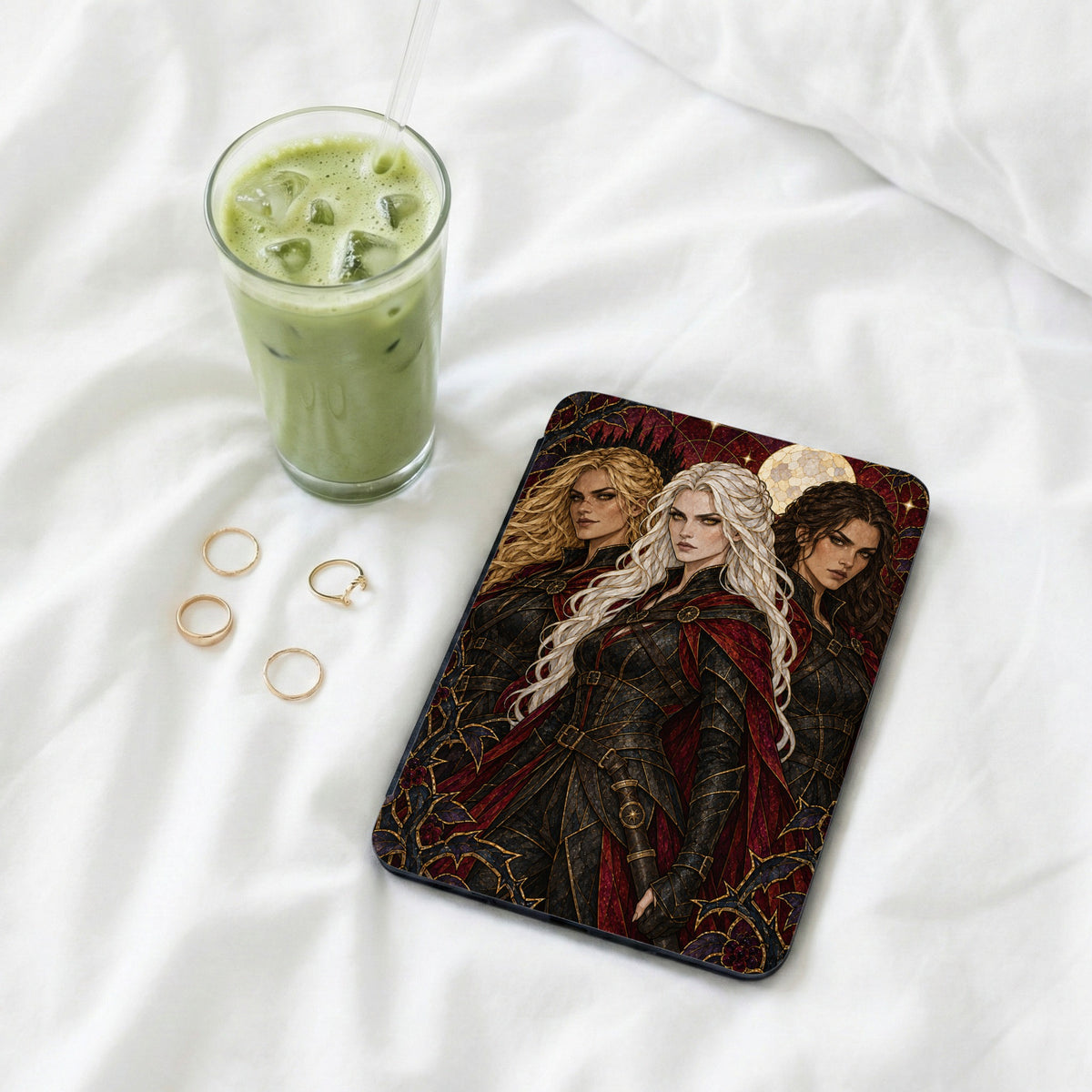 Book cover art featuring three warrior women with intricate armor and capes.