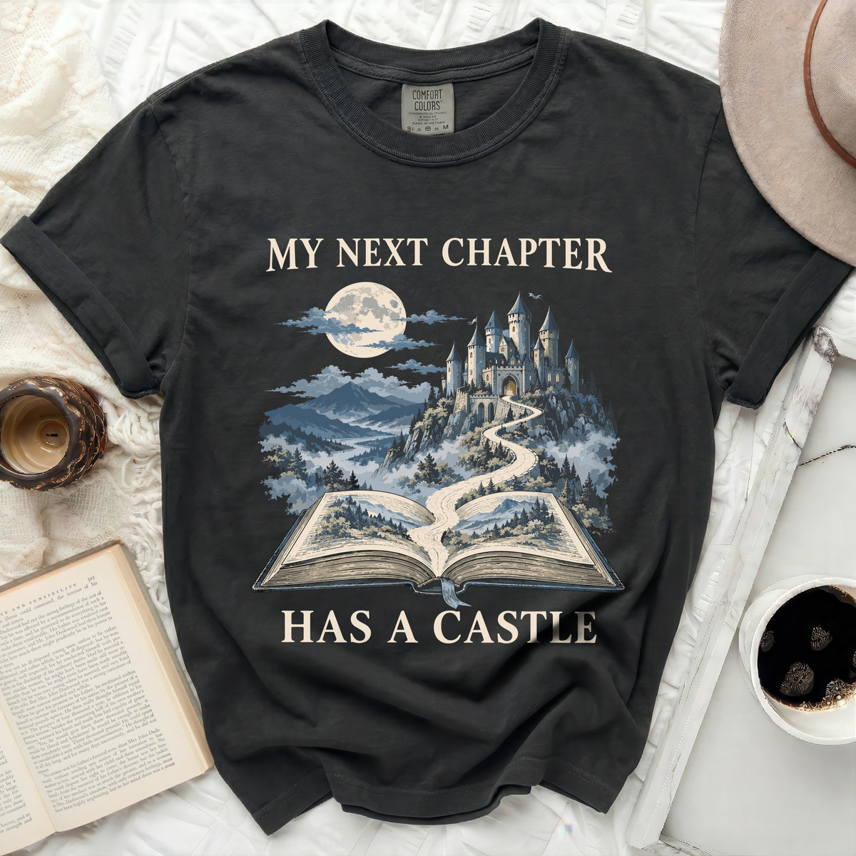 T-shirt with "My Next Chapter Has a Castle" text and castle graphic.