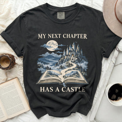 T-shirt with "My Next Chapter Has a Castle" text and castle graphic.