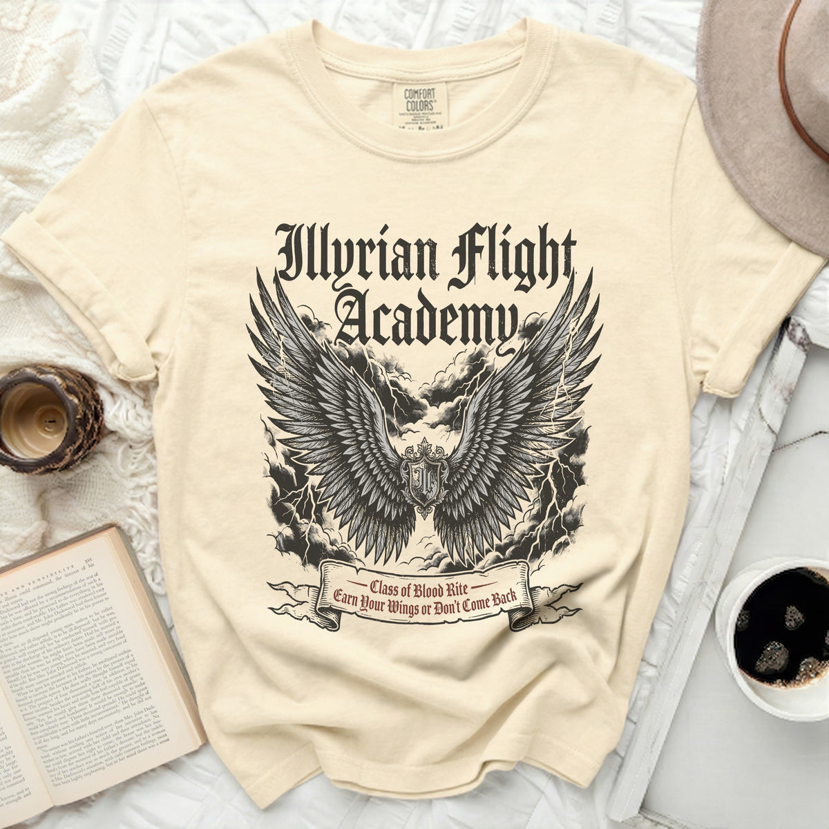 Cream t-shirt with "Illyrian Flight Academy" text and winged crest.