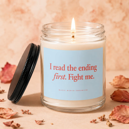 Candle with lid off, lit wick, and label that reads "I read the ending first. Fight me."