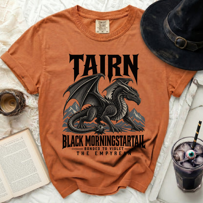 Orange t-shirt with a black dragon graphic and text "TAIRN BLACK MORNINGSTARTAIL THE EMPYREAN".