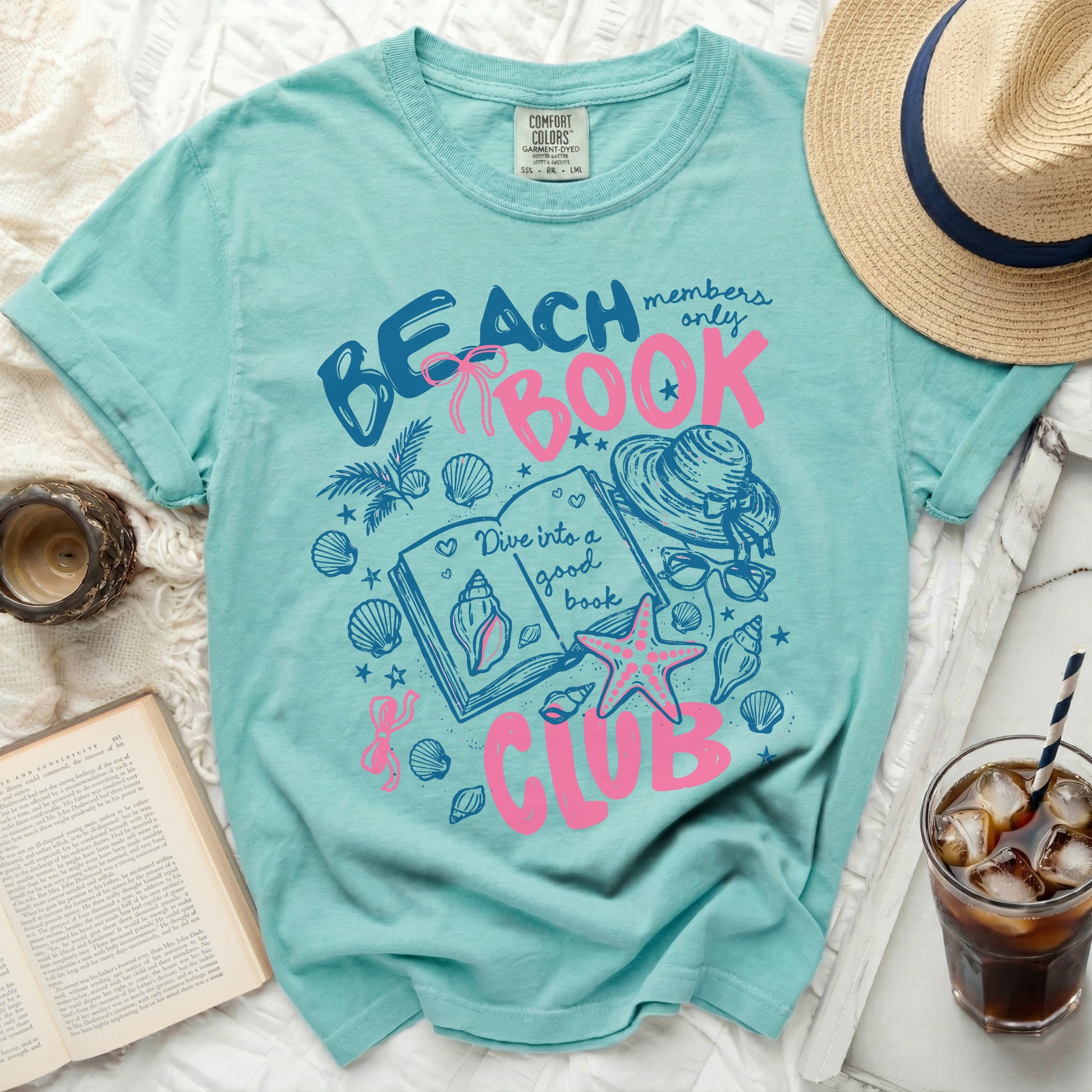 Aqua t-shirt with "Beach Book Club" graphic and seashells.