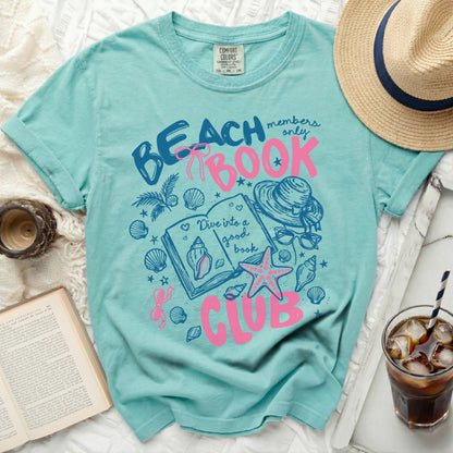 Aqua t-shirt with "Beach Book Club" graphic and seashells.