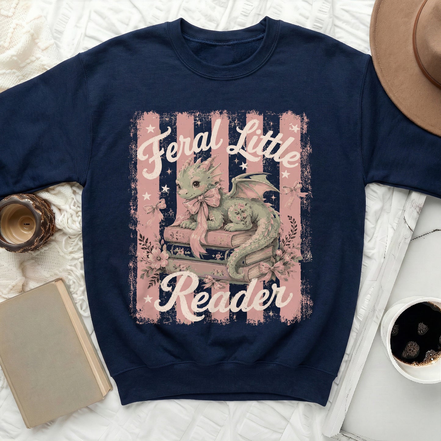 Navy sweatshirt with a green dragon reading books, "Feral Little Reader" text.