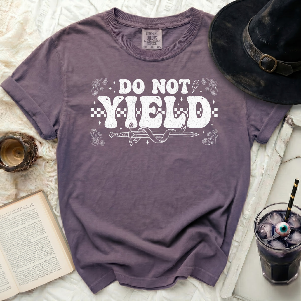 Purple t-shirt with "DO NOT YIELD" and a sword graphic.