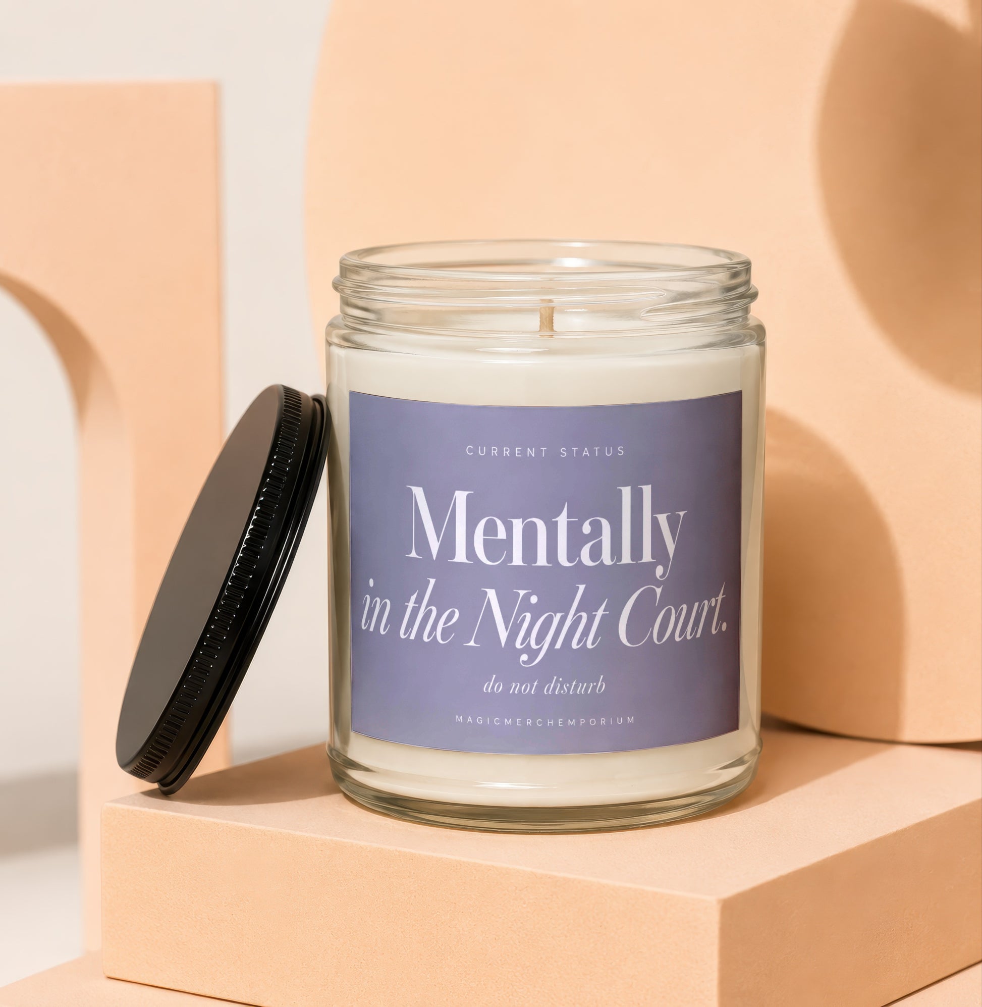 Glass candle with black lid and lavender label reading "Mentally in the Night Court. do not disturb."