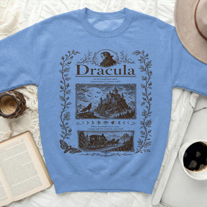 Light blue sweatshirt with "Dracula" graphic featuring spooky castle, bats, and carriage.