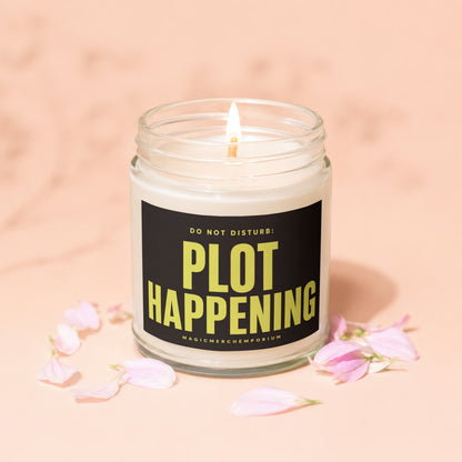 Candle in glass jar with black label reading "DO NOT DISTURB: PLOT HAPPENING".