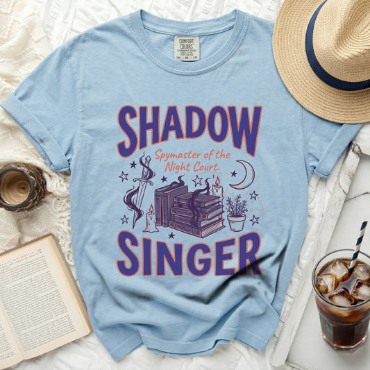 Light blue t-shirt with "SHADOW Spymaster of the Night Court. SINGER" graphic.