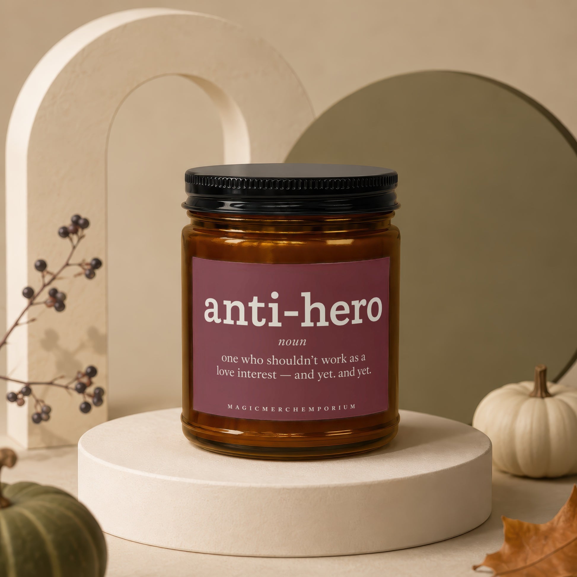Amber candle in a jar with "anti-hero" definition label.