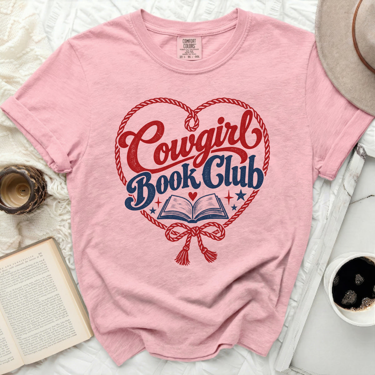 Pink t-shirt with "Cowgirl Book Club" graphic in a heart shape.