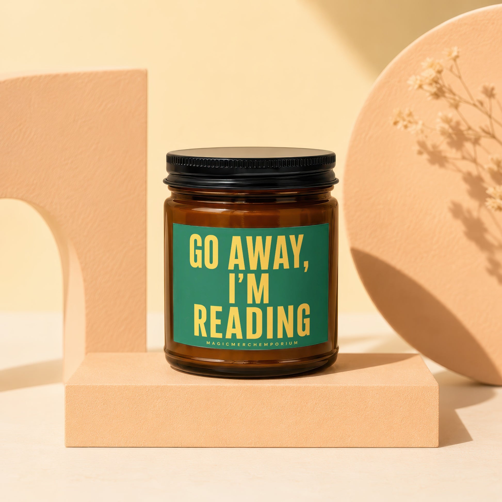 Amber candle with "GO AWAY, I'M READING" text on a green label.