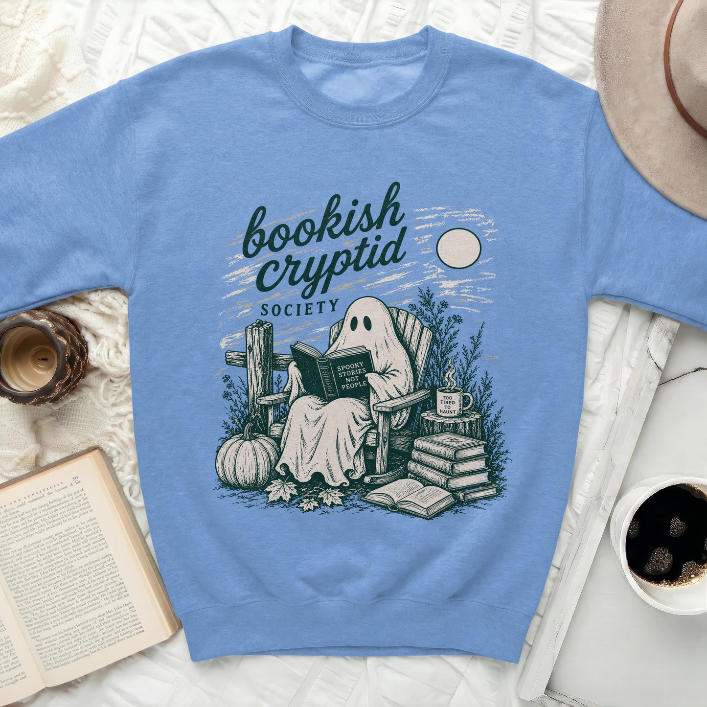 Ghost reading a book with "Spooky Stories Not People" text on a sweatshirt.